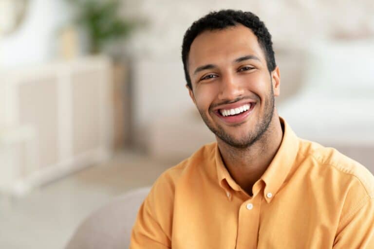 Professional Teeth Whitening at One44 Dental in Rotherham. Image of a man from shoulders up, smiling with a beautifully white smile.